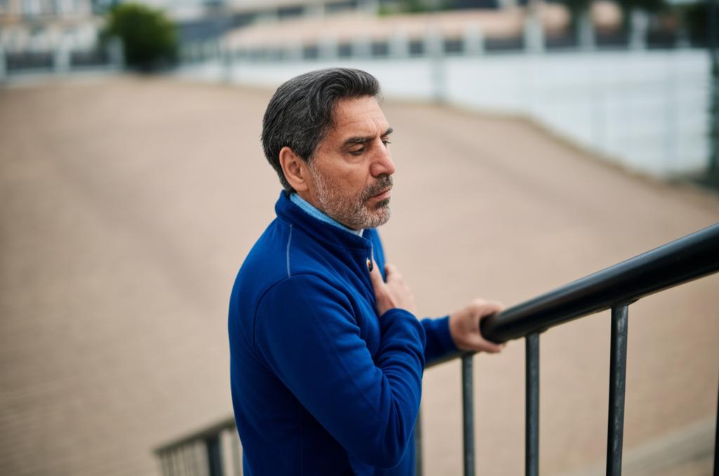 Middle-aged man looking tired while climbing stairs, feeling out of breath, realistic style